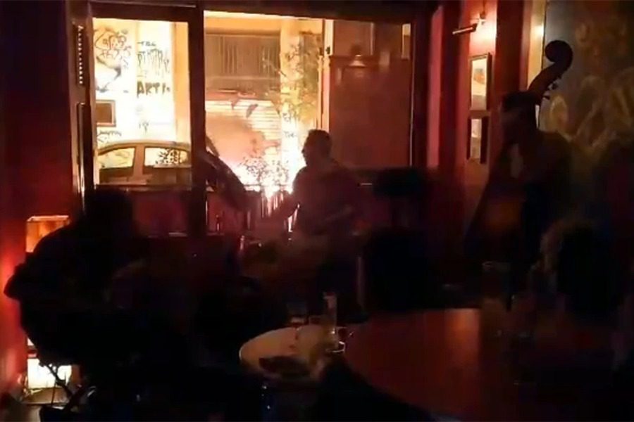 Εξάρχεια: Μπάντα παίζει μουσική ενώ πέφτουν βροχή οι μολότοφ