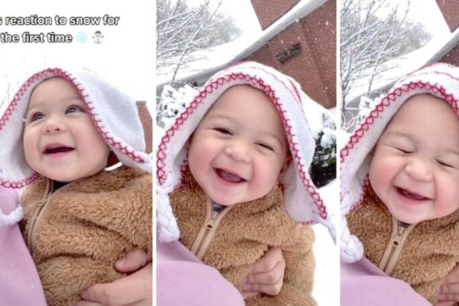 Μωρό βλέπει για πρώτη φορά χιόνι και το απολαμβάνει